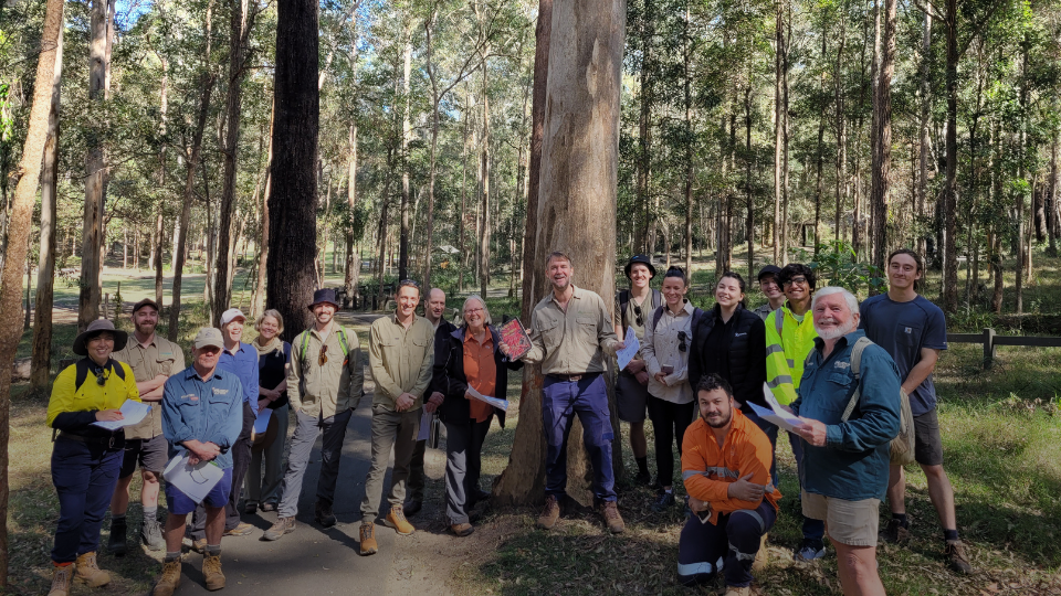 A group of smiling conservation volunteers in Daisy Hill Conservation Park, Logan.